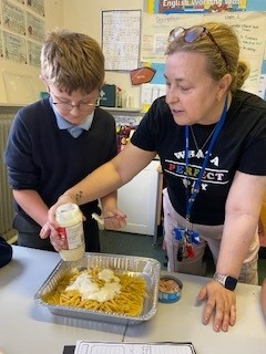 Adding sauce to our pasta bake