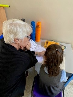 Adult and child reading a story book