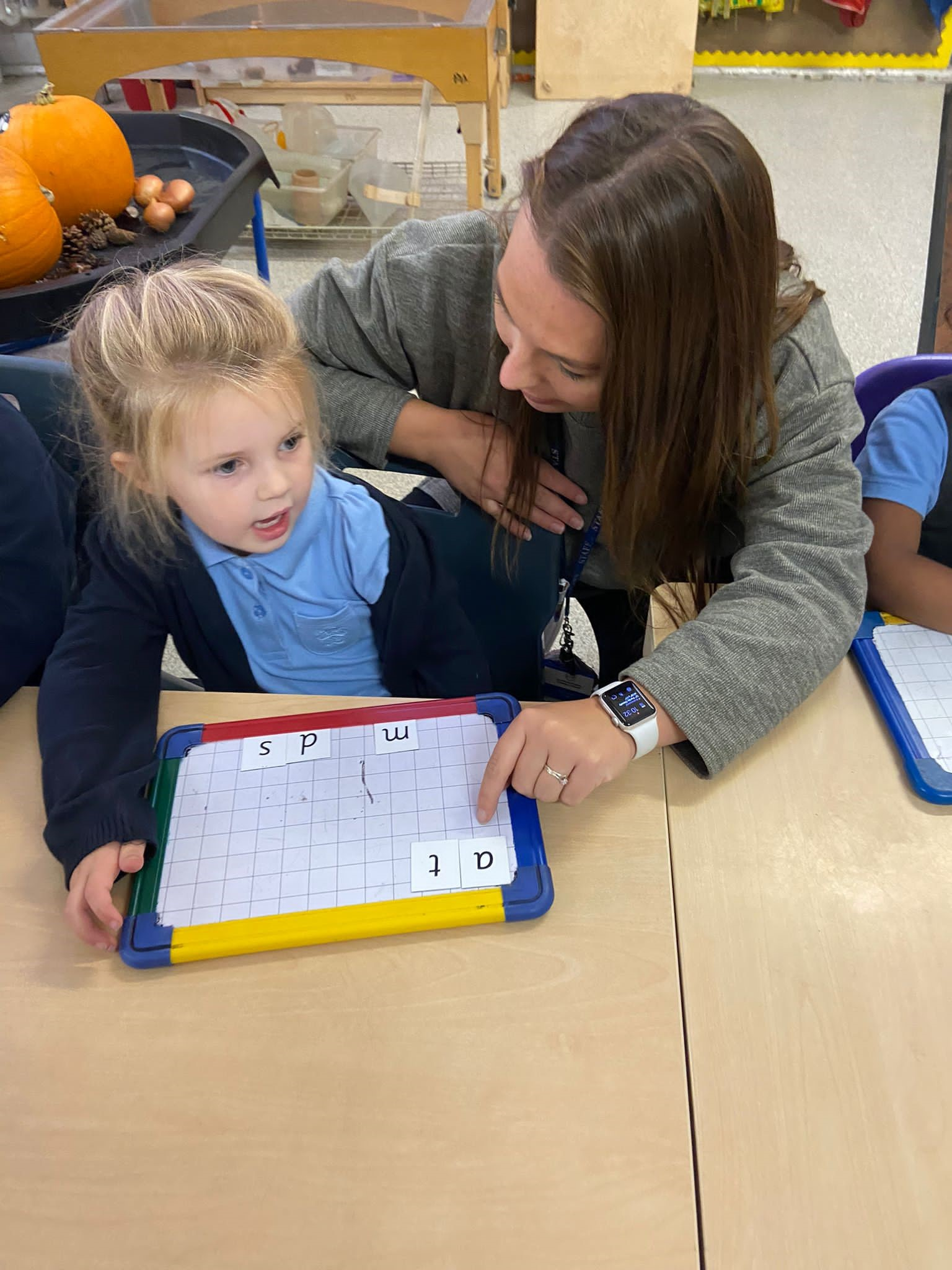 Adult and child  using a whiteboard for learning